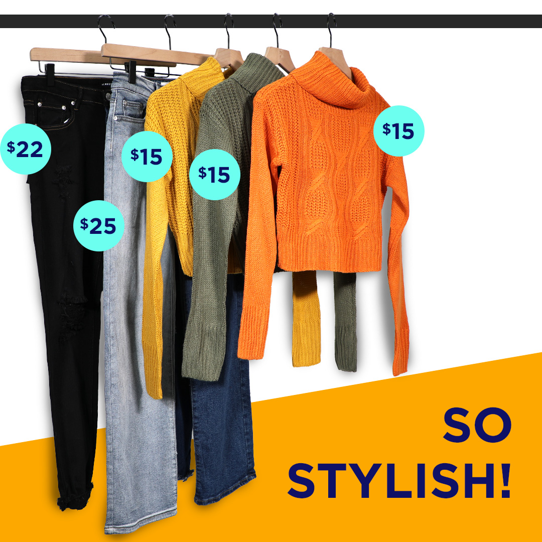 Sweaters and jeans on a clothing rack